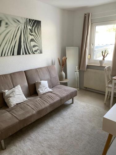 a living room with a couch and a zebra picture at Schöne moderne 2-Zimmerwohnung in Göppingen