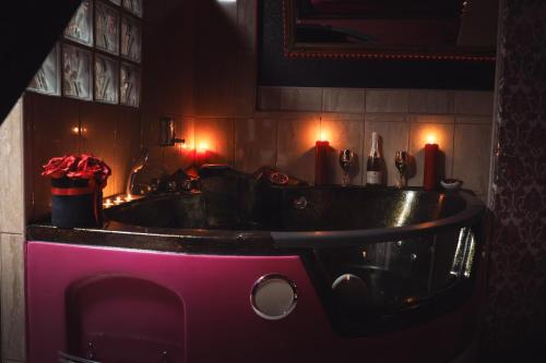 a sink in a bathroom with red candles on the wall at WELLNESS privátní - Brno in Lískovec