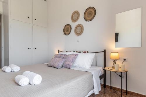 a bedroom with a bed with two towels on it at Family Home Naxos in Naxos Chora