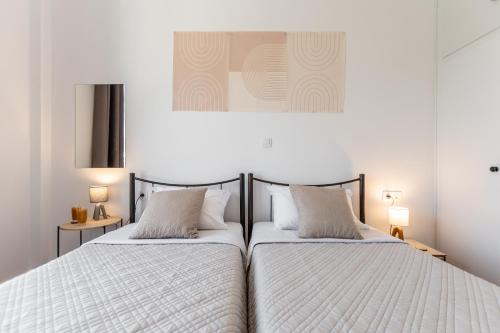 two beds sitting next to each other in a bedroom at Family Home Naxos in Naxos Chora
