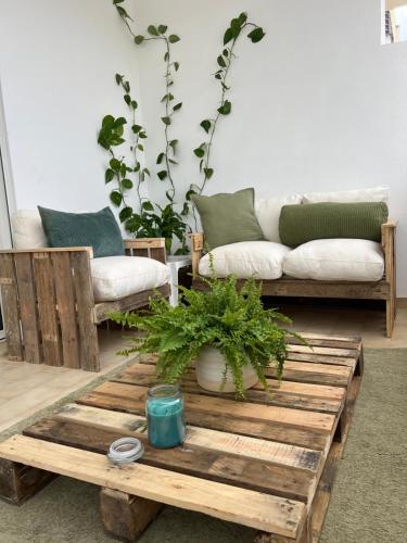 a living room with a couch and a coffee table at Ilumina Hostel Albufeira in Albufeira