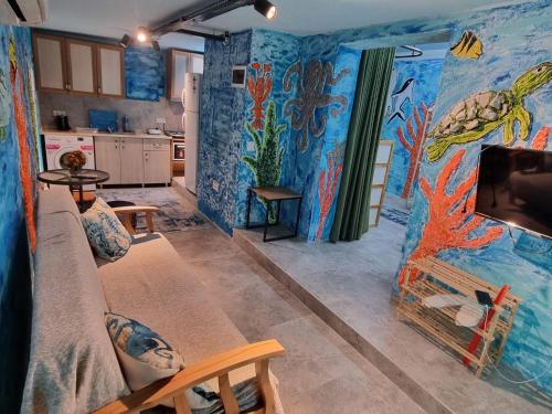 a kitchen with a room with a painting on the walls at Ayşem Mill Hill Houses in Bodrum City