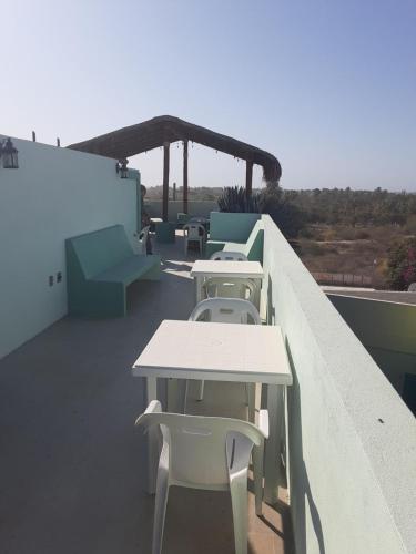 a row of tables and chairs on a balcony at Posada Nomad in San José del Cabo