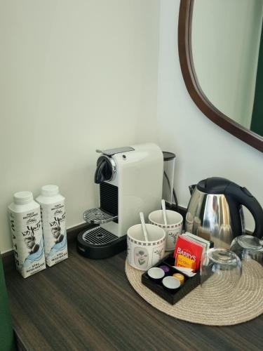 a table with a coffee maker and a toaster at Hidden Acres- Deluxe Double Room in Malahide