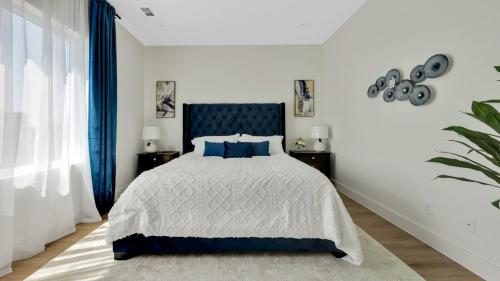 a bedroom with a bed with a blue head board at Uptown Escape l Stylish Stay near Downtown Dallas in Dallas
