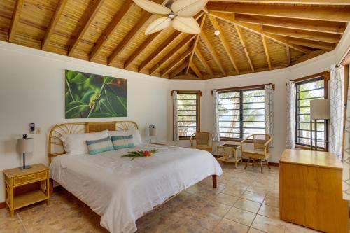 a bedroom with a bed and a ceiling fan at Beachfront Villa Deep Pool Sleeps 6 Private Suite in Maya Beach