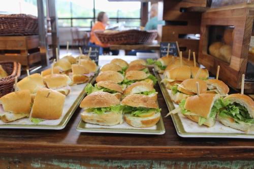 a bunch of sandwiches on plates on a table at Resort QSB - Um novo padrão de conforto e lazer no coração da cidade in Pirenópolis