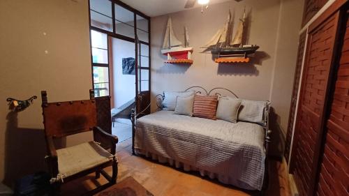 a bedroom with a bed and models of boats on the wall at Lovely 2 Bedrrom Casita with Bay view in Zihuatanejo