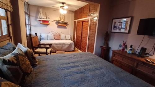 a bedroom with a bed and a bedroom with a bed sqor at Lovely 2 Bedrrom Casita with Bay view in Zihuatanejo