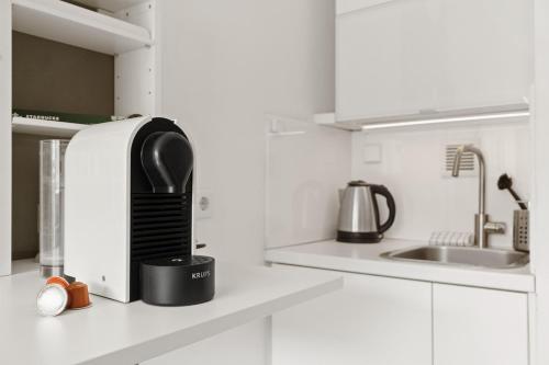 a kitchen with a black appliance on a counter at Smart City Apartment in Bestlage! self check-in, Neu! in Cologne