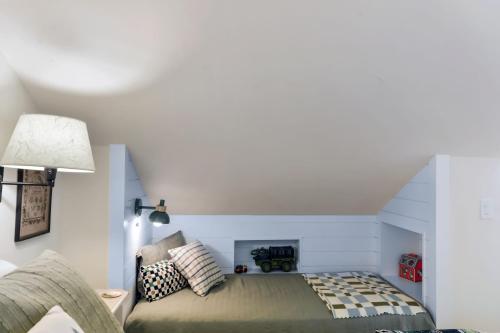 a bedroom with a bed in the corner of a room at Harbor Light at the Beach in Saint Simons Island