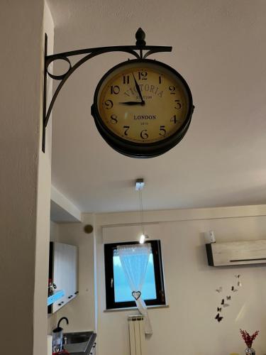 a clock hanging from the ceiling of a room at La finestra su Assisi in Bastia Umbra