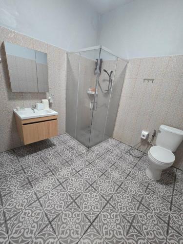 a bathroom with a shower and a toilet and a sink at Chaba 4 family in Nakhon Nayok