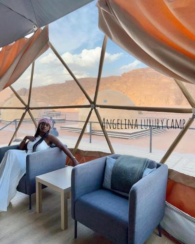 a person sitting in a room with a view of an airport at Angelina Luxury Camp in Wadi Rum