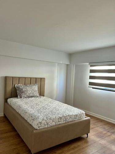 a bedroom with a bed and a window in it at Vila Mehmeti in Delvinë