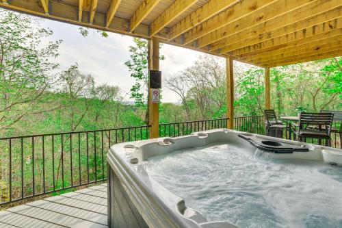 a jacuzzi tub on the deck of a house at Pet-Friendly Branson Area Home Hot Tub, Game Room in Reeds Spring