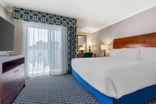a hotel room with a bed and a window at Best Western Plus Marina Shores Hotel in Dana Point