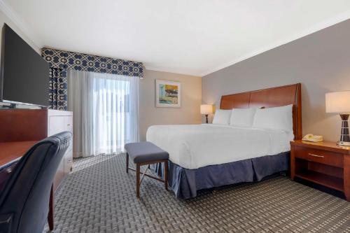 a hotel room with a bed and a television at Best Western Plus Marina Shores Hotel in Dana Point