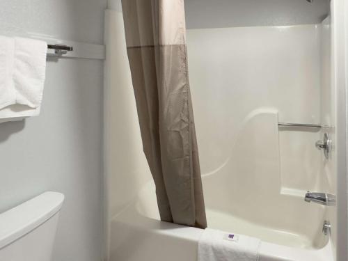a white bathroom with a shower and a toilet at Motel 6-Dyersburg, TN in Dyersburg