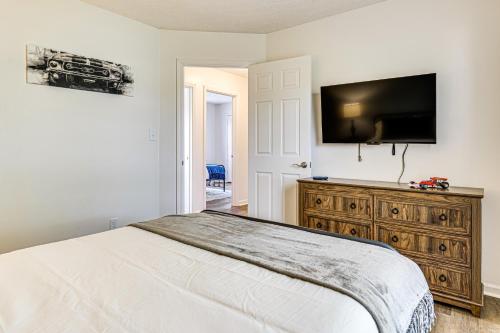 a bedroom with a bed and a flat screen tv at 9 Mi to Dtwn Indianapolis Family-Friendly Home! in Indianapolis