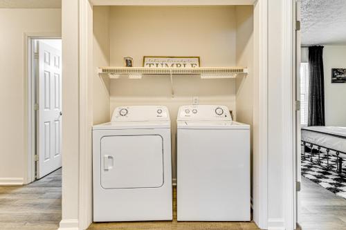 two washing machines in a laundry room with a shelf at 9 Mi to Dtwn Indianapolis Family-Friendly Home! in Indianapolis