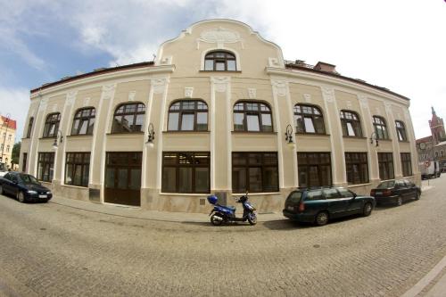 a building with a motorcycle parked in front of it at Hotel Vabank in Golub-Dobrzyń