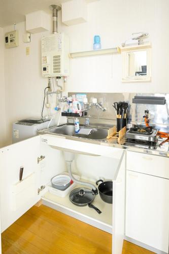 a kitchen with a sink and a counter top at バンビハイツ長嶋304 in Aomori