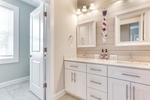 a white bathroom with two sinks and a mirror at Surf City House about 400 Ft Walk to Beach with Decks! in Surf City