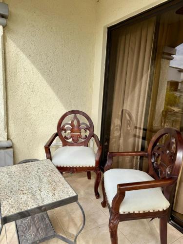 two chairs and a table on a balcony at Relaxing 1BR Oasis near Tamarindo in Villarreal