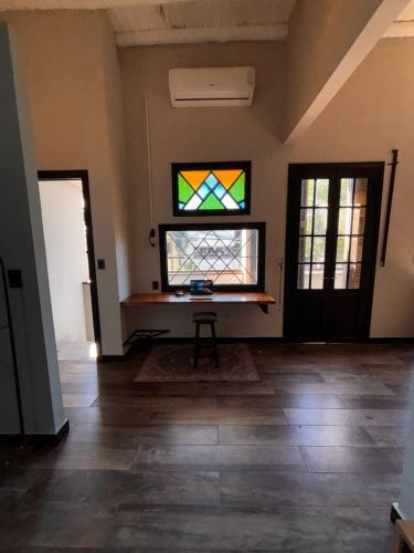 a room with a table and a stained glass window at Departamento divino a media cuadra del Faro de la Costanera in Vuelta del Paraguayo