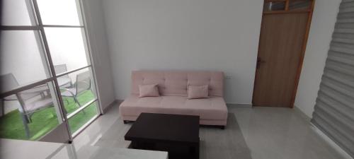 a living room with a couch and a table at Nuevo y moderno departamento in Sucre