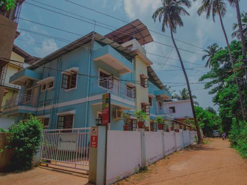 a house with a windmill on top of it at Super Collection O Holy Cross Home Stays in Goa