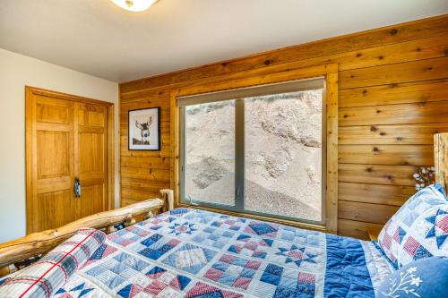a bedroom with a bed and a window at Lakefront Divide Cabin with Game Room! in Woodland Park