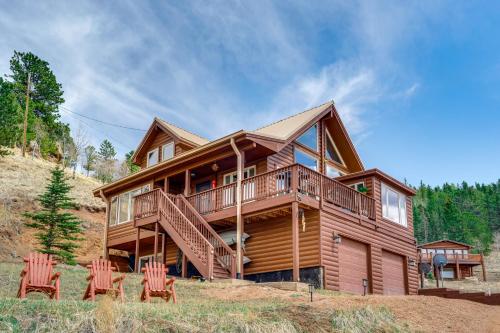 a wooden house with four chairs in front of it at Lakefront Divide Cabin with Game Room! in Woodland Park