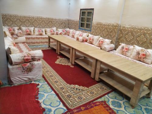 a living room with a couch and a table at almou auberge Imilichil in Imilchil