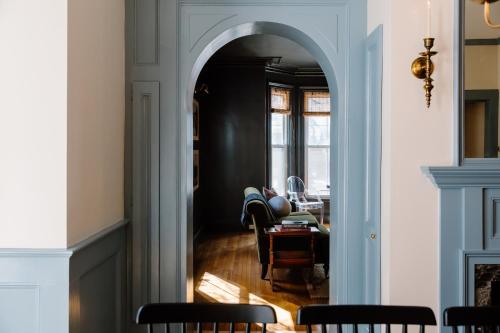 an archway in a room with a table and chairs at The Ipswich Inn in Ipswich
