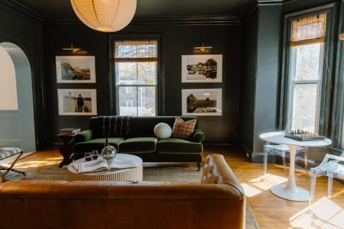 a living room with a couch and a table at The Ipswich Inn in Ipswich