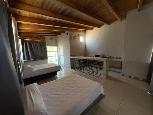 a large room with two beds and a kitchen at La Altanera in Troncones