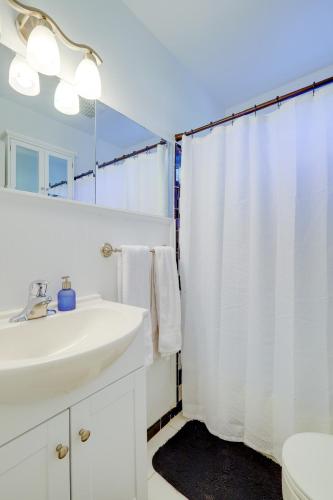 a white bathroom with a sink and a shower curtain at 2 Bed Charming Home Cayce W Columbia in Cayce