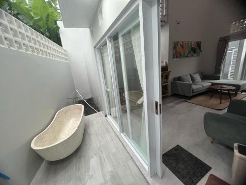 a living room with a tub in the corner of a room at Smooth Villas in Ngasinan