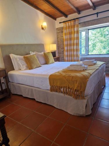 a bedroom with a large bed in a room at Casa de Sao Miguel Douro in Armamar