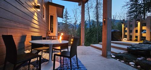 a table and chairs on a patio with a candle at Casa del Rio - Peaceful River Guest Suite -Forests -Mountains -Hiking in Chilliwack