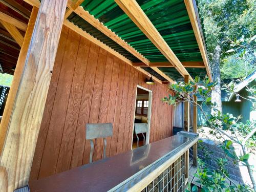a wooden building with a bench on a porch at Comfy Studio near Trails & Beaches in Lagunitas