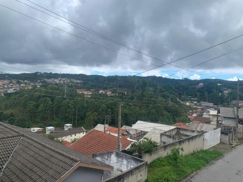 a view of a city with houses and trees at My Yellow House Casal in Campos do Jordão