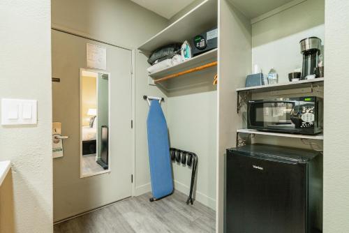 a kitchen with a blue tie hanging on a wall at Urban Boutique Hotel- Little Italy, Downtown San Diego in San Diego
