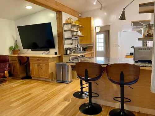 a kitchen with a counter with two bar stools at Comfy Studio near Trails & Beaches in Lagunitas