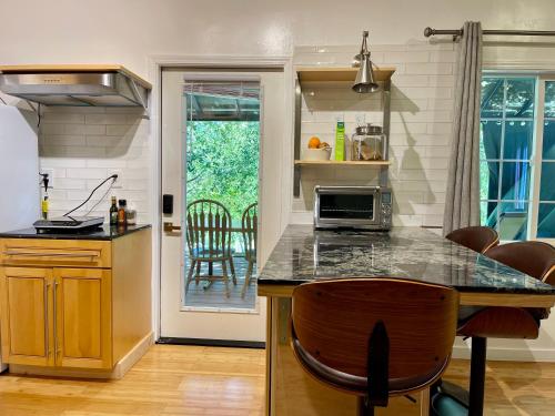 a kitchen with a counter top and a table with chairs at Comfy Studio near Trails & Beaches in Lagunitas