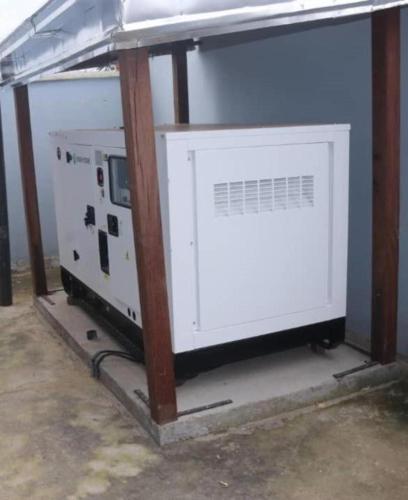 a large white machine sitting in a room at The Blue Resort in Yaoundé