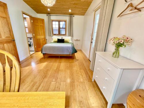 a bedroom with a bed and a table with a vase of flowers at Comfy Studio near Trails & Beaches in Lagunitas