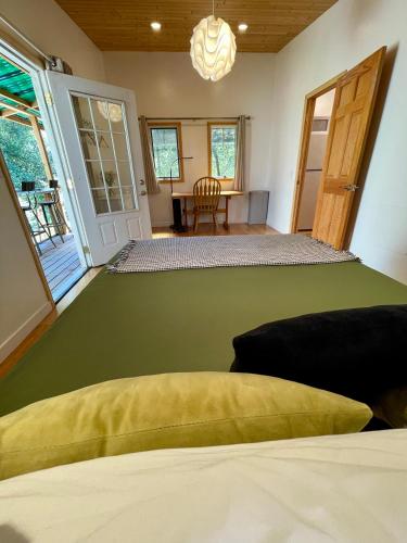 a bedroom with a large green bed in a room at Comfy Studio near Trails & Beaches in Lagunitas